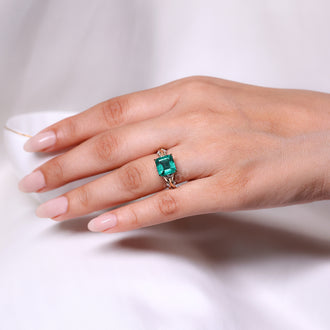 Twisted shank emerald engagement ring design.
