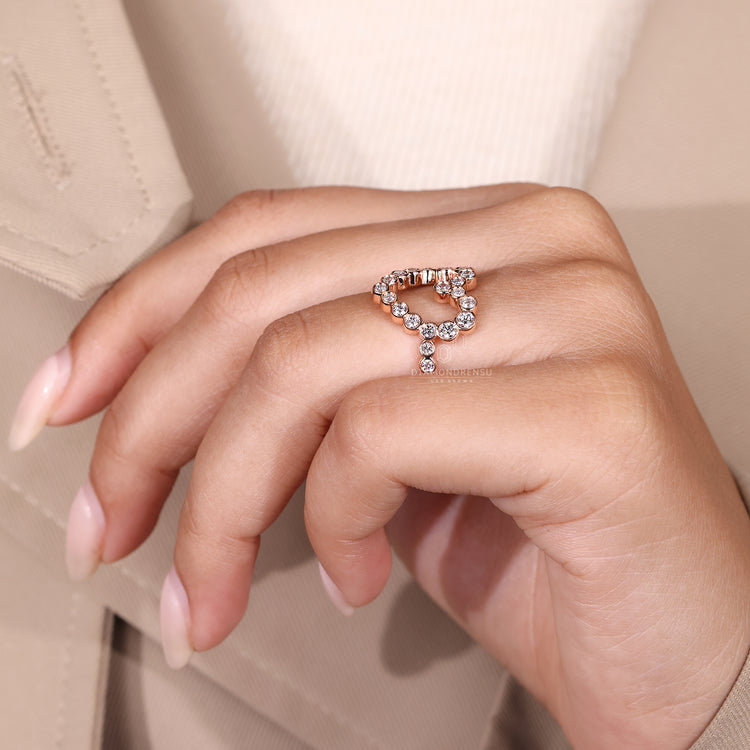 Pave setting ring with heart shaped diamond in rose gold.
