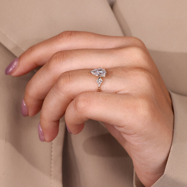 Three stone art deco design with pear cut engagement ring Diamondrensu.
