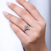 Muse setting ring with marquise cut engagement diamond in cathedral setting.
