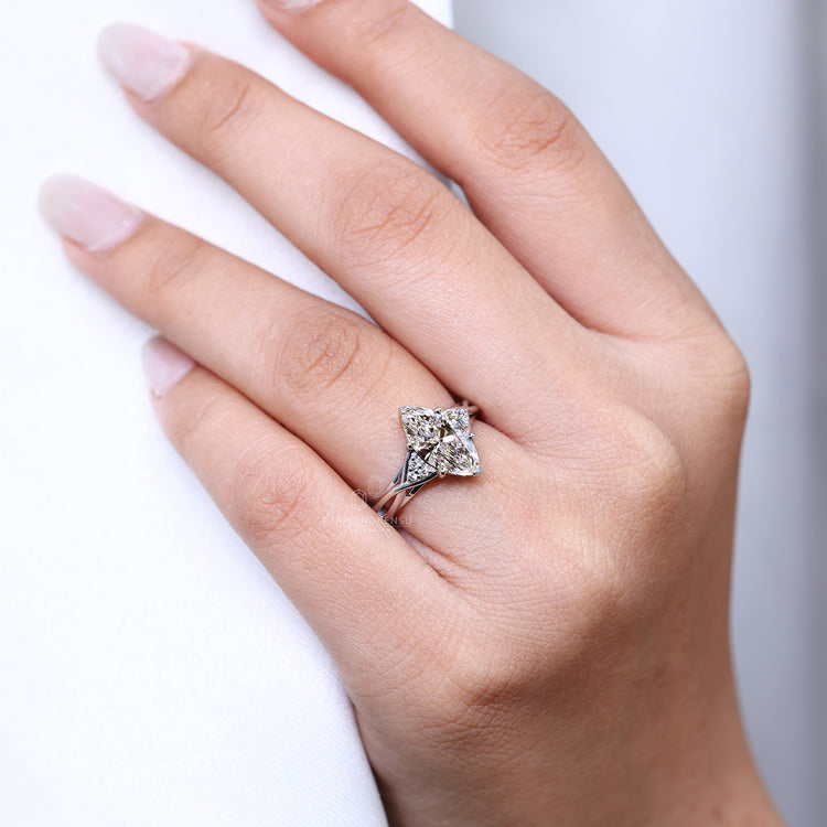 Muse setting ring with marquise cut engagement diamond in cathedral setting.
