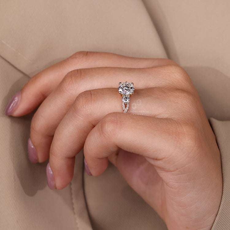 Three stone round cut engagement ring with 4 prong setting.
