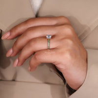 Four Prong Ring Setting holding a green diamond in a two-tone diamond ring.
