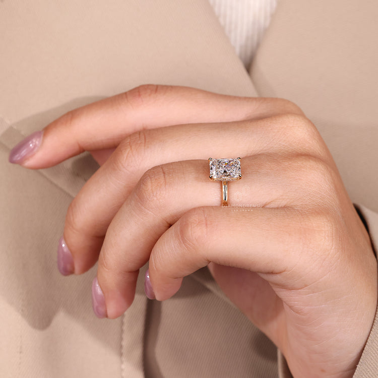 Round cut hidden halo paired with radiant cut engagement diamond ring.
