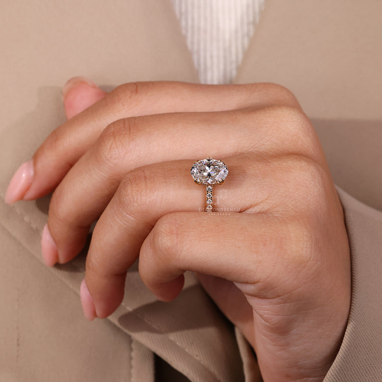 Handmade ring featuring oval diamond with hidden halo and pave details.
