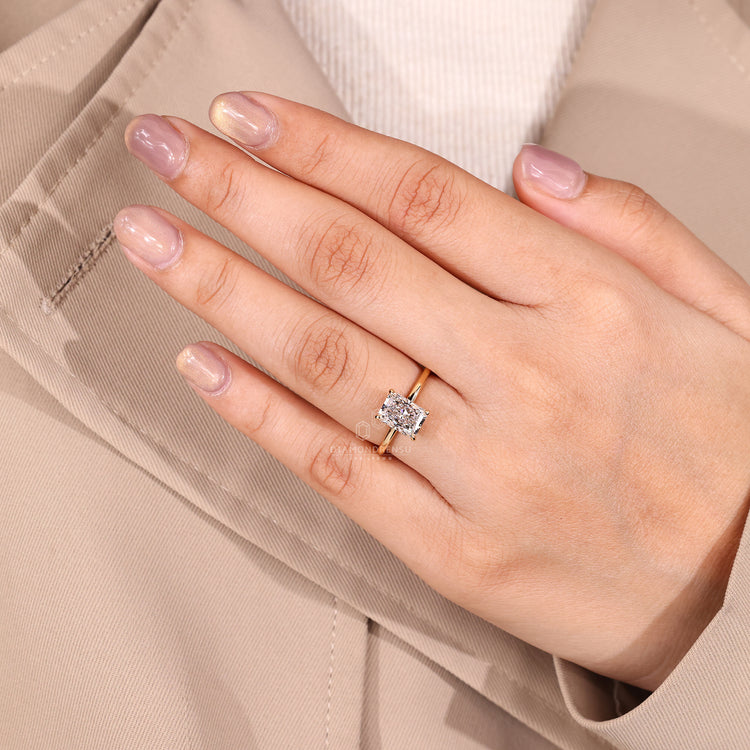 Four claw prong ring holding radiant cut diamond in halo setting.
