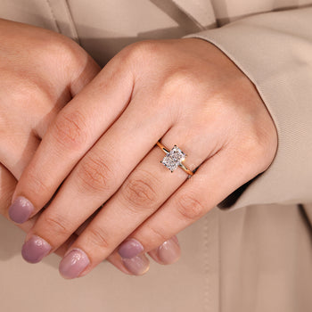 Solitaire setting ring with radiant cut diamond and round cut hidden halo.
