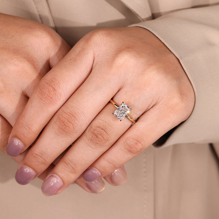 Solitaire setting ring with radiant cut diamond and round cut hidden halo.
