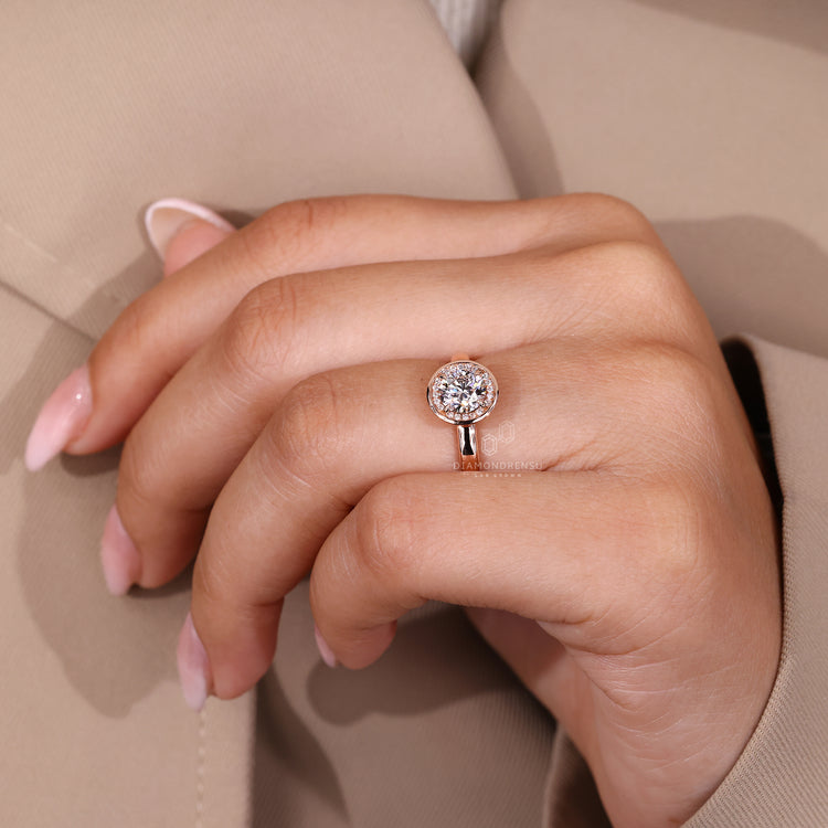 Handmade ring with rose gold band and round diamond halo design.
