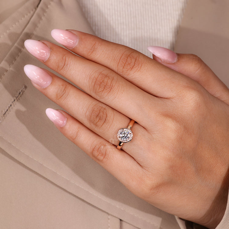 Round cut diamond ring with handmade jewelry and halo detail.
