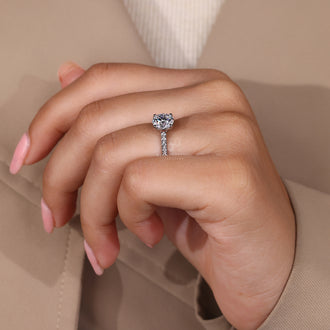 White gold diamond ring with delicate pave accents on the band.
