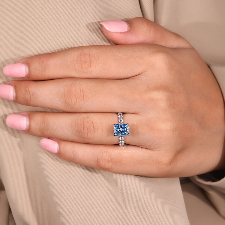 IGI certified handmade ring with blue diamond and pave accents.
