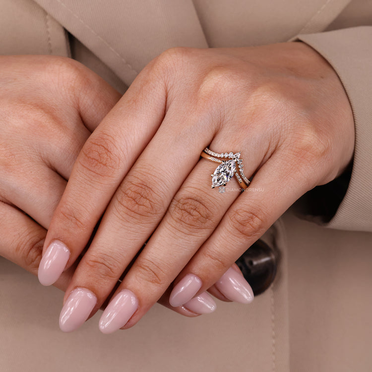 Pear and round cut band complements the wedding ring.