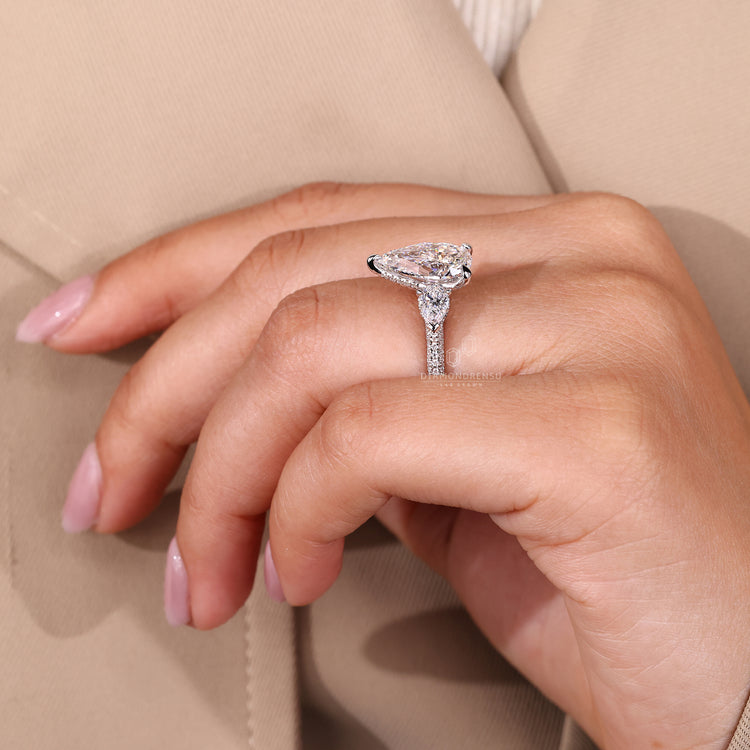 White gold engagement ring with pear cut diamond in 3 claw prong.
