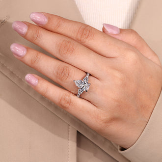 Round cut pave band ring paired with pear cut diamond center.
