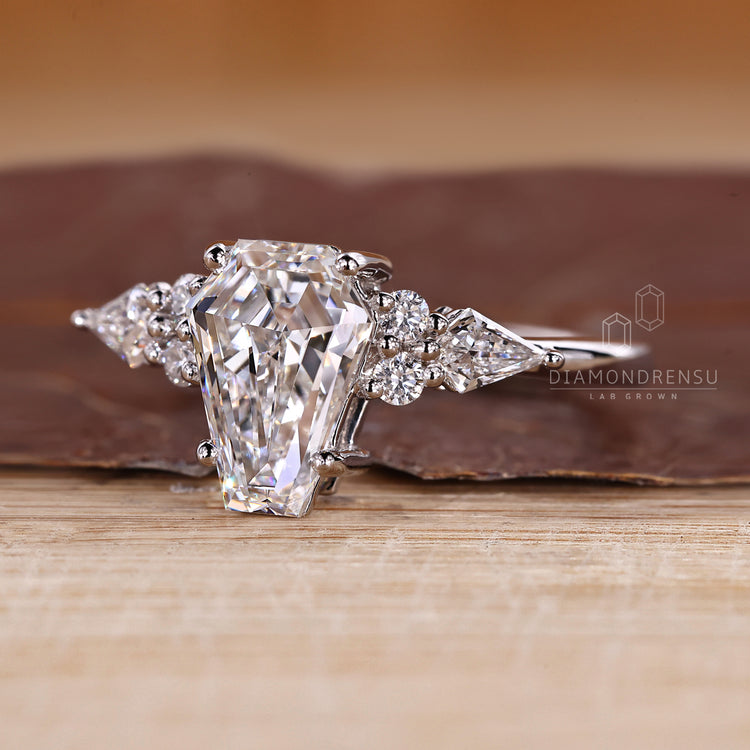 Diamondrensu coffin ring with lab grown diamond center.