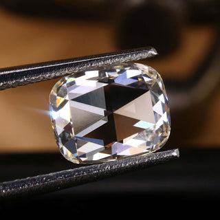 This 1.37 carat diamond features an elongated rose cut cushion design.
