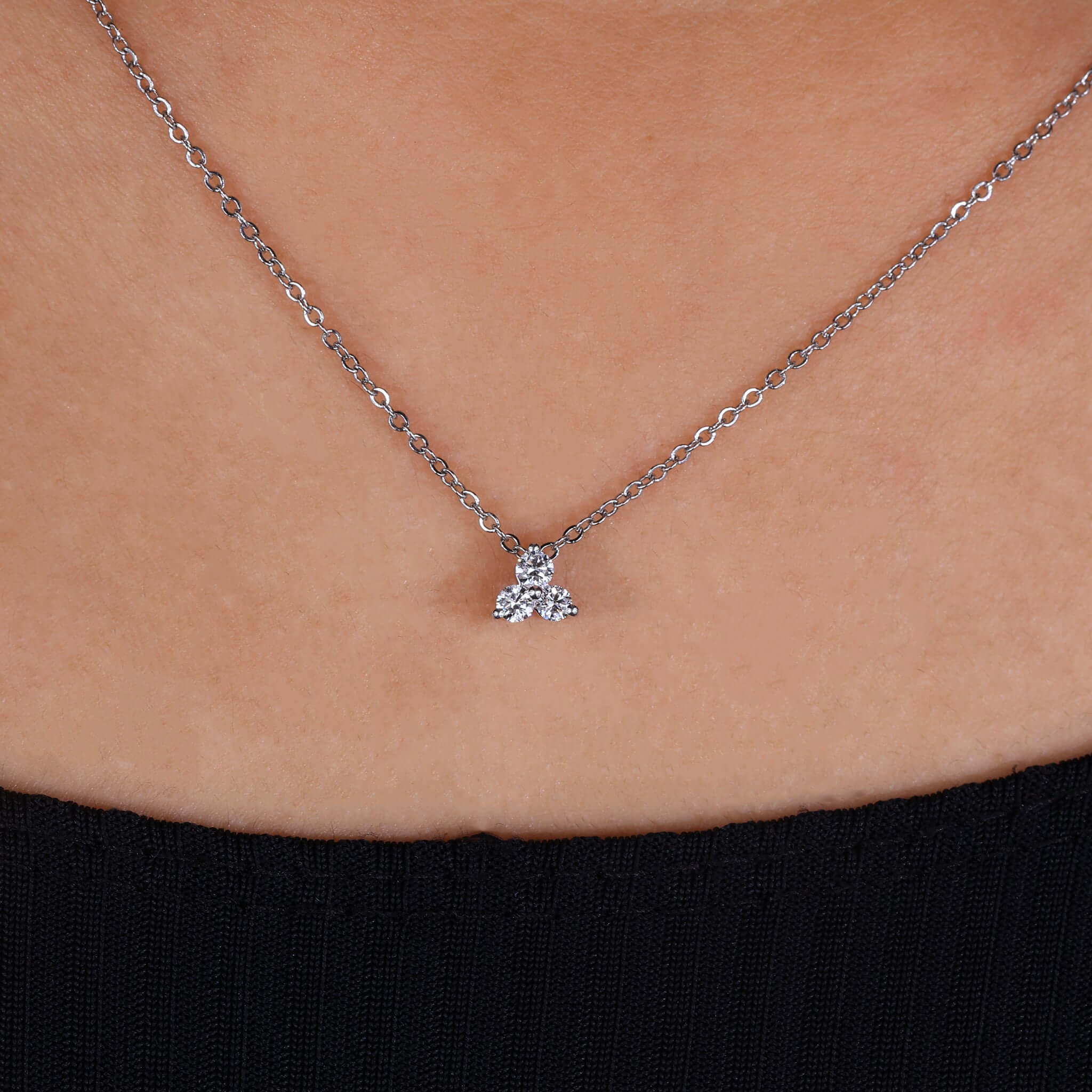 Elegant round diamond pendant, shimmering with brilliance against a soft background.