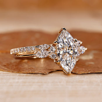 Marquise ring wedding band with marquise and round side stones.