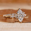 Marquise ring wedding band with marquise and round side stones.