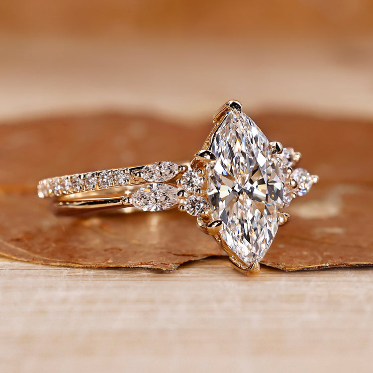 Marquise ring wedding band with marquise and round side stones.