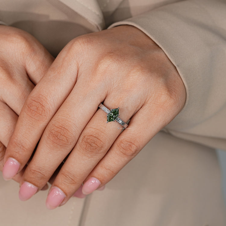 Dutch marquise diamond ring with round stones along the bridge.