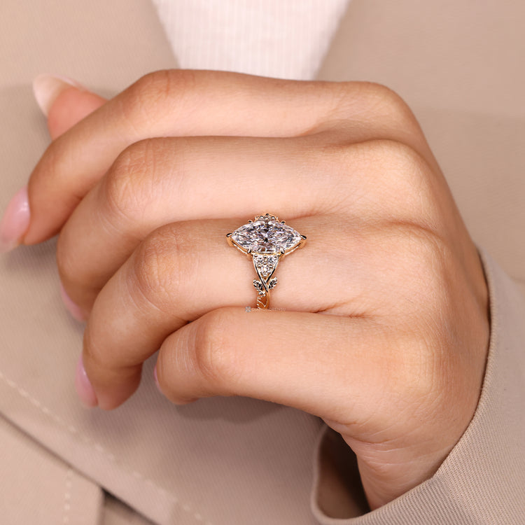 Marquise center stone ring with nature inspired side stone arrangement.