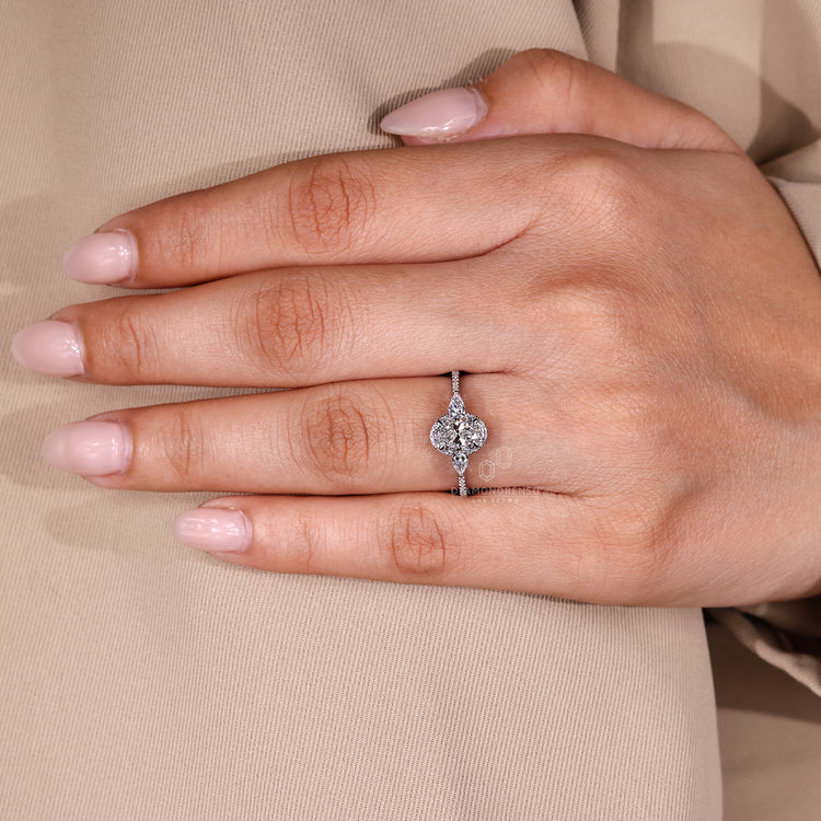 Handmade oval engagement ring with halo and pear stones.