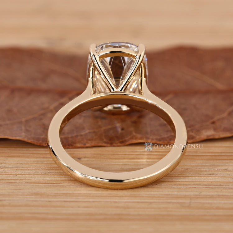 Cushion old mine cut diamond ring with four claw prongs.