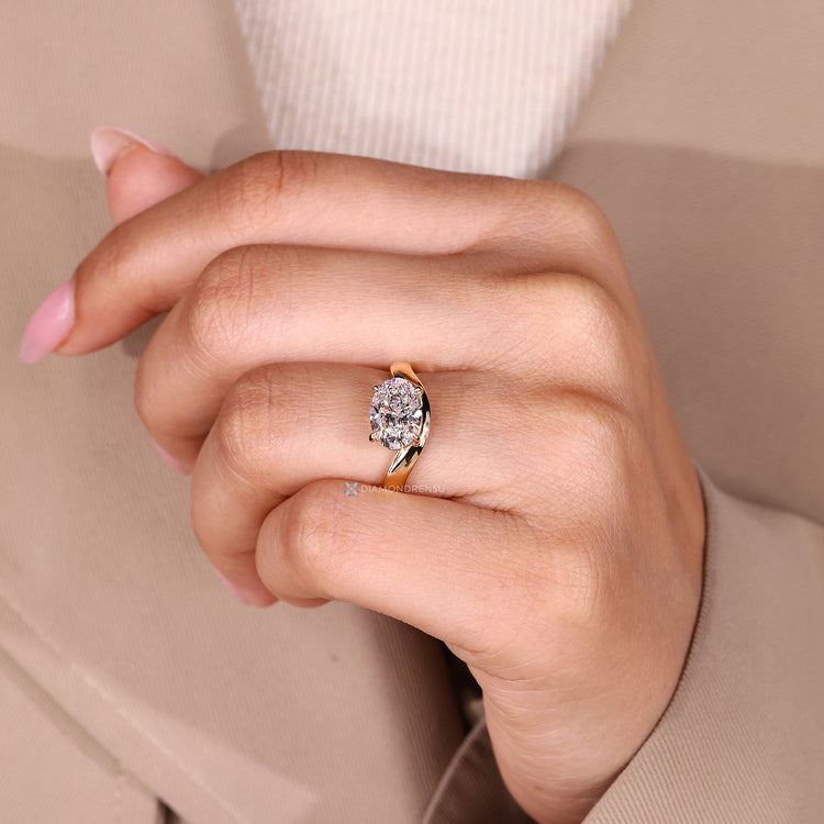 Oval cut engagement ring with solitaire style and prong setting.