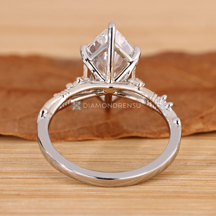 Dutch marquise ring with a branch inspired design and round side stones.