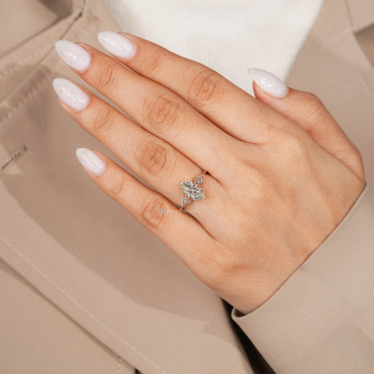 Three stone diamond ring with a tapered shank.