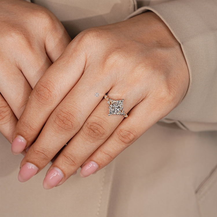Dutch marquise ring with six claw prongs and diamond accents.