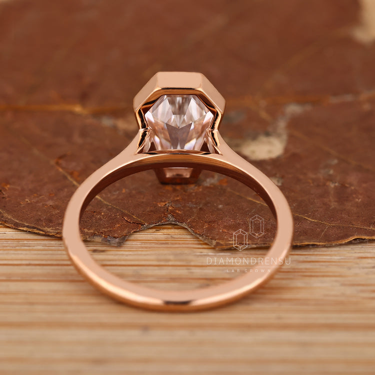 Handmade coffin diamond ring with secure bezel setting.