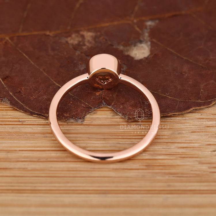 IGI certified round diamond ring with bezel set style.