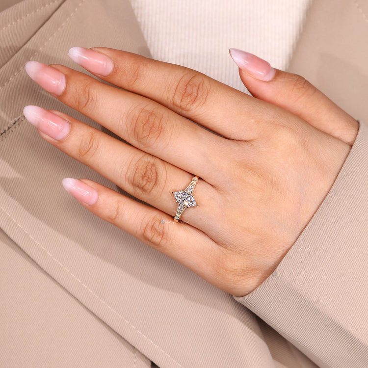 Marquise engagement ring with cathedral setting and prong details.