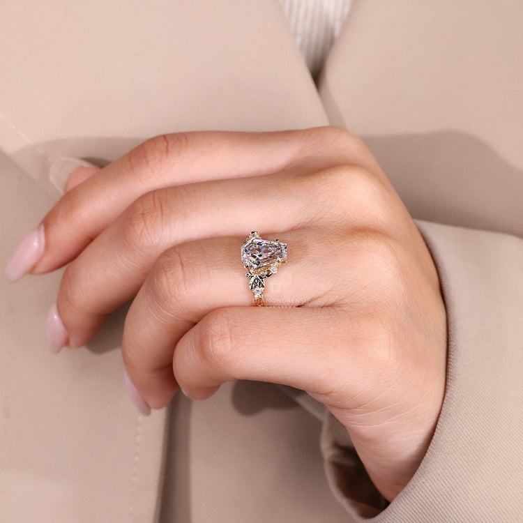 Nature inspired engagement ring with round side stone details.