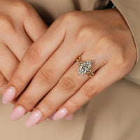 Tulip setting with marquise and round side stones.