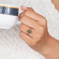 Green marquise diamond ring with a tulip setting.