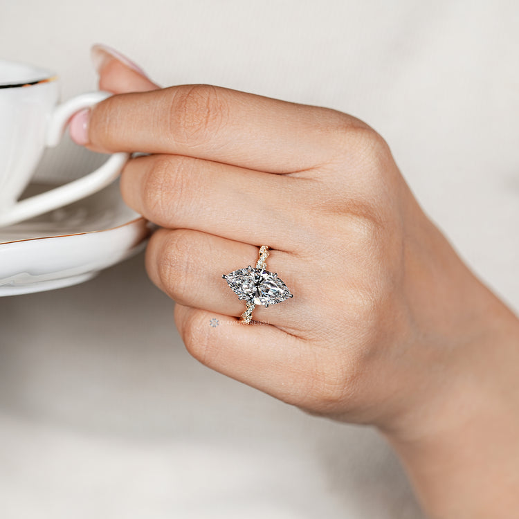 Tulip setting supports the marquise center stone.