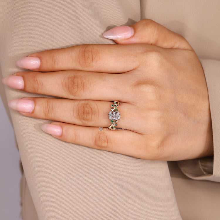 Radiant center stone with marquise side stones and green emerald gemstones.