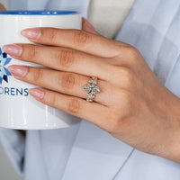 Nature inspired engagement ring with round side stones.