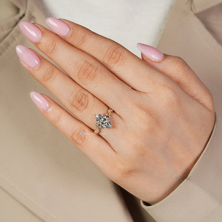 Tulip setting supports the marquise center stone.
