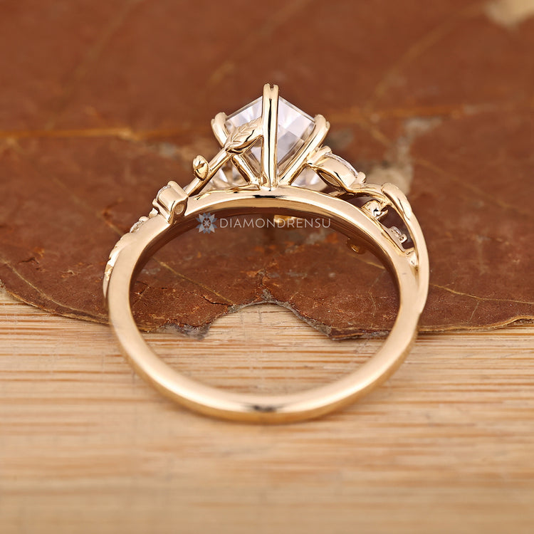 Hexagon diamond ring with nature inspired styling and side stones.