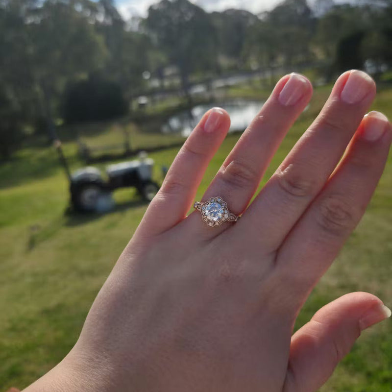 Diamond engagement ring displayed outdoors on a hand