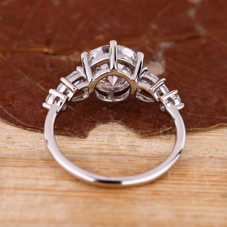 White gold engagement ring with round diamond and prongs.
