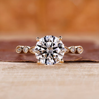 Round diamond engagement ring with milgrain setting.
