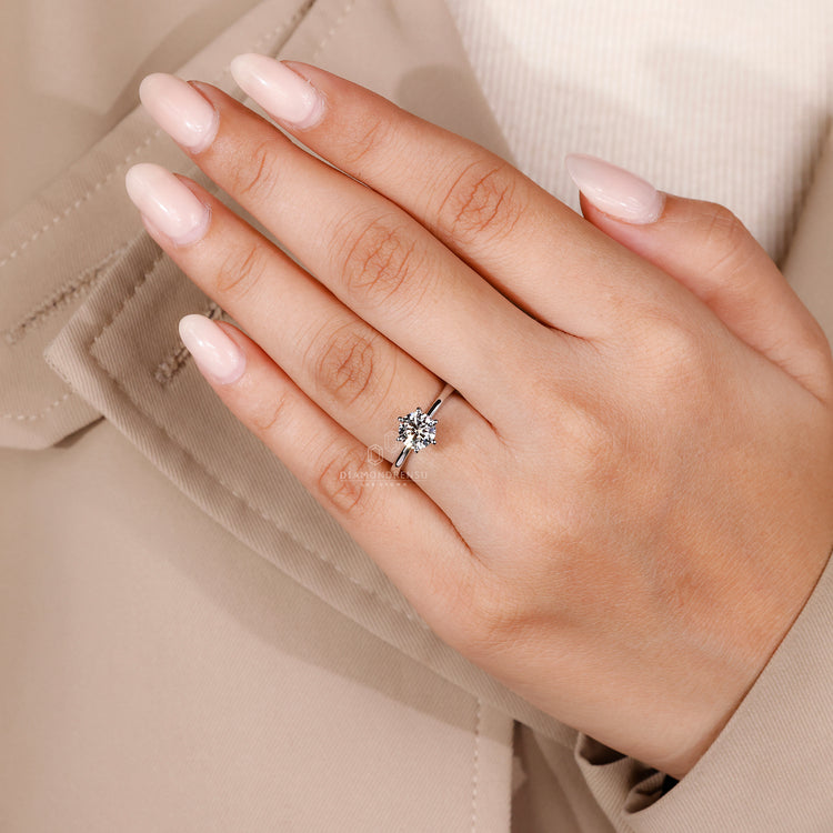 Solitaire diamond ring in a hidden milgrain setting, offering a unique texture in a modern design.
