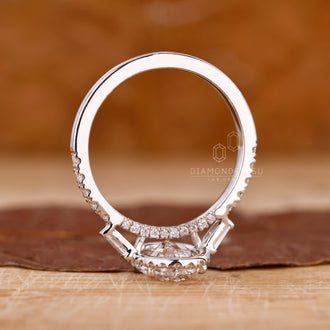 Handmade ring crafted as a three stone ring with side diamonds.
