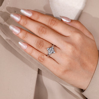 V shaped prong ring holding marquise cut diamond in handmade jewelry.
